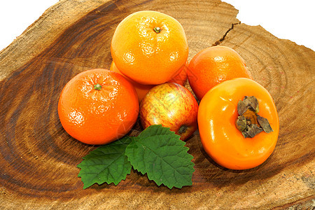 木头上的橙 苹果和过膜柚子叶子青菜团体饮食杂货柿子奇异果食物收藏图片