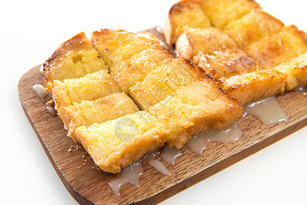 面包面包和木板上的冷凝牛奶黄油午餐牛奶黄色甜点食物小吃营养早餐白色图片