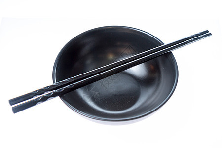 碗桌上的黑筷子用具陶器白色美食文化黑色木头盘子餐厅图片