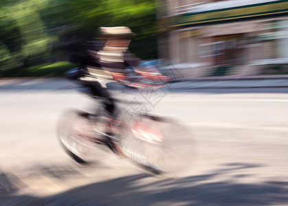 在城市公路上交通中骑自行车的男孩男人踏板生态骑士速度街道车轮汽车道路城市图片