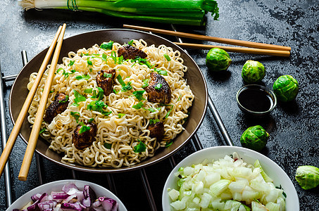 亚洲鸡面沙拉绿色白色洋葱胡椒面条美食筷子海鲜芝麻午餐图片