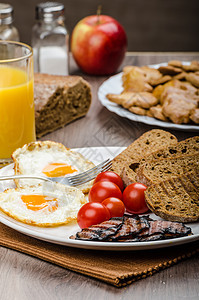 早餐培根 香肠 面包和鸡蛋蛋黄午餐猪肉带子油炸桌子食物盘子晴天用餐图片