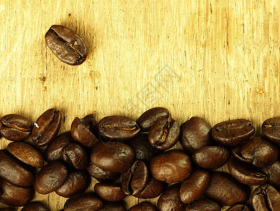 咖啡豆紧贴木制橡木桌咖啡茶几早餐背景时间豆子桌子时光休息棕色图片