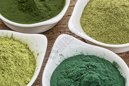 健康健康的绿色饮食补充海藻辣木粉末陶瓷木头小麦白色营养制品小球藻图片