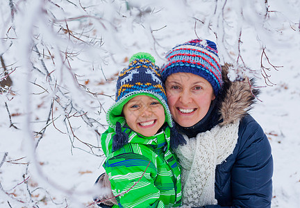 与母亲同在的冬季男孩孩子快乐幸福男性乐趣天气男生微笑季节游戏图片