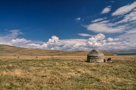吉尔吉斯斯坦的Yurts住宅山脉游牧民族绿色风景家畜草原丘陵部落图片