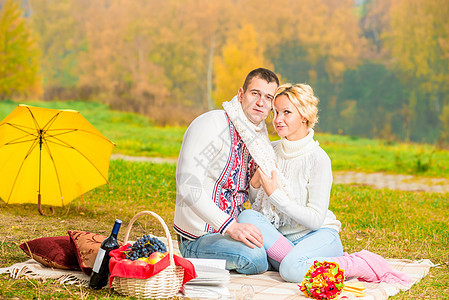 在秋公园一个美丽的环境里 野餐的年轻小情侣图片