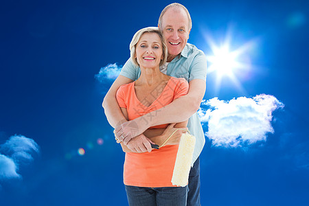 拥抱天空幸福的老夫妇拿着彩彩卷的复合图像男人微笑亲密感男性服装金发绘图快乐头发计算机背景