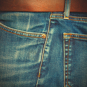 带棕色皮皮腰带的牛仔裤缝合配饰衣服裤子金属铆钉照片蓝色侧袋棉布图片