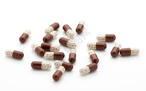 白底的抗生素胶囊棕色宏观草本白色保健处方药片科学卫生药品图片