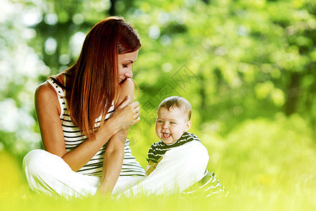 母亲和女儿在公园乐趣童年女性微笑婴儿绿色家庭女士喜悦父母图片