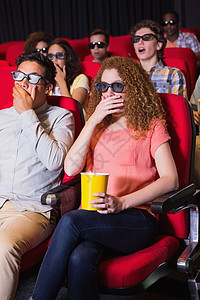 年轻朋友在看一部3D电影活动男性震惊礼堂椅子红色女性演出时间文艺图片