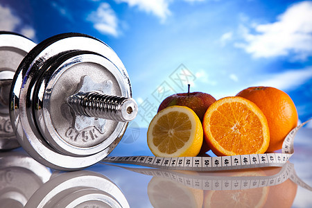 丁铃和绿草 明亮多彩的音调概念卷尺身体测量饮食尺寸建筑营养状况哑铃重量图片