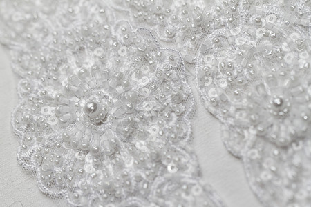 珍珠工艺结婚礼带细节裙子魅力蜜月订婚仪式蕾丝工艺刺绣珍珠织物背景