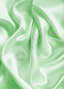 平滑优雅的绿色丝绸或作为背景的沙子海浪材料柔软度折痕蓝色织物投标布料折叠涟漪图片