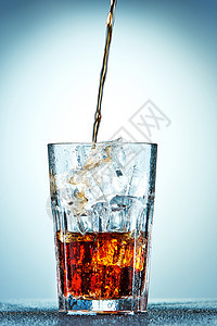 倒在玻璃杯里的可乐果汁水晶流动生活派对运动饮料杯子液体食物图片