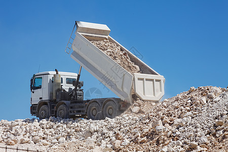 Tipper 卡车倾倒商业机械放电机器工业石头货物车辆岩石图片