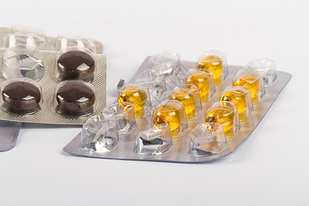 药丸 Blister条形中的维他命化学化工卫生黄色胶囊药片保健棕色吸塑条药品背景图片
