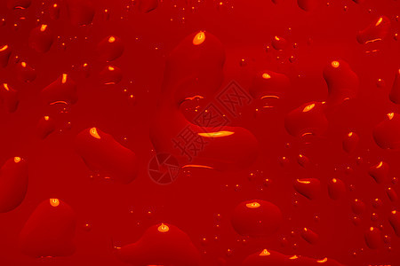 红色抽象背景与水滴液体气泡雨滴珠子艺术宏观飞沫玻璃图片