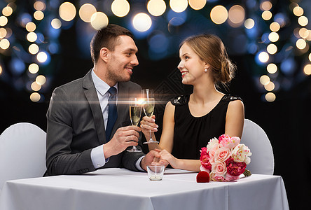 一对夫妇在餐厅 喝香槟的杯子女朋友干杯家庭蜡烛玫瑰订婚男朋友盒子奢华纪念日图片