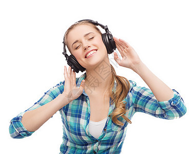 青年妇女用耳机收听音乐闲暇学生娱乐手机收音机打碟机微笑歌曲女孩青少年图片