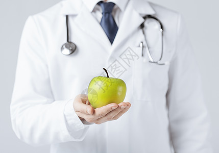 具有绿苹果的男男性医生药品损失长袍产品生物消化水果重量卫生数字图片