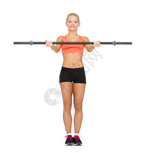 微笑着运动的女子用巴铃锻炼运动员身体二头肌培训师哑铃数字重量训练健美健身房图片
