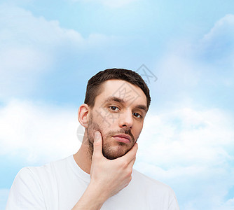 美丽的平静的男人摸着他的脸头发拉丁胡须男性脸颊治疗皮肤成人天空卫生图片