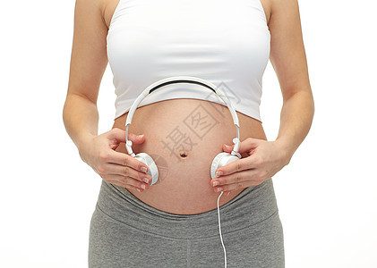 孕妇和腹部耳机紧闭的孕妇和耳机孩子婴儿母性怀孕母亲肚子产妇父母歌曲生活图片