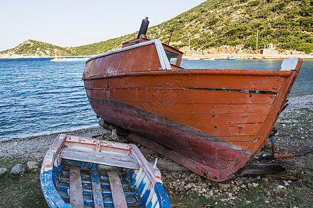 希腊阿洛尼索的海滩上被抛弃的拖网钓鱼者海岸船体粉碎天空卵石港口衰变蓝色残骸破坏图片