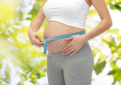 孕妇腹部测量仪表的紧闭控制女性重量树叶分娩尺寸肚子婴儿家庭母亲图片