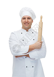 快乐的男厨师拿着滚针做饭餐厅职员白色糕点滚动首席男性食物面包美食图片
