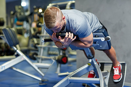年轻男子在体育馆的长凳上伸展背肌肉权重男人运动装运动健美腹部火车腹肌男性力量图片