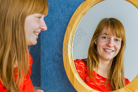 红发女孩照镜子的肖像图片