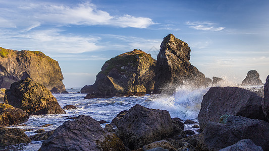 在落岩海岸撞碎波浪海岸阳光海浪蓝色地平线海岸线天空海滩太阳橙子图片