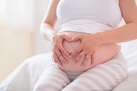 怀着重力的孕妇服装身体怀孕卧室护理女性腹部孕妇装休闲女士背景图片