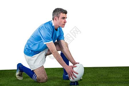 橄榄球运动员准备踢一脚分数体育竞技播放器蓝色服装男人专注运动服竞赛图片