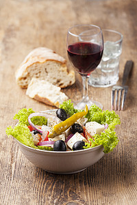 带橄榄的新鲜希腊沙拉辣椒叶子美食木头起动机刀具洋葱蔬菜面包戒指图片
