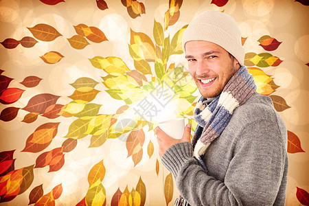 冬季时装的英俊男子综合形象 拿着杯子季节树叶环境计算机热饮羊毛潮人帽子橙子快乐图片