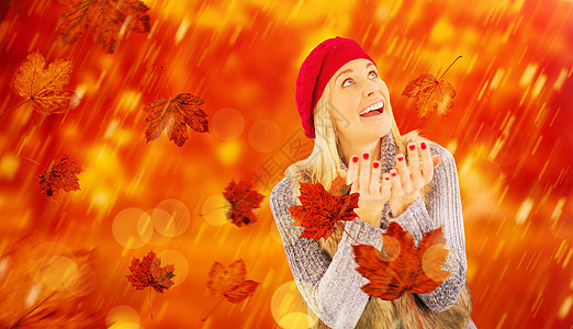 冬衣金发的复合形象 双手伸出手羊毛树叶农村女性草原冬装衣服快乐微笑帽子图片