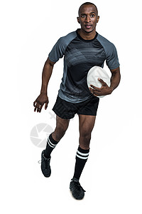 橄榄球运动员自信的运动员与橄榄球赛跑肌肉跑步男人男性竞技运动黑色活力体育服装背景