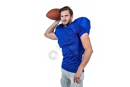 美国橄榄球运动员扔球的球头盔服装运动体育竞赛蓝色男人运动服投掷足球图片