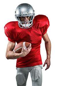 美国足球运动员穿红球衣 带着球跑的肖像图片