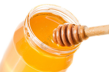 白色背景的蜂蜜罐头 顶上有木制蜂蜜花金子塞子花蜜玻璃治愈饮食营养工作室食物产品图片