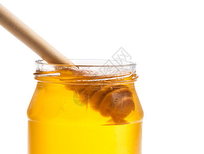 在白色背景上打开蜂蜜罐 里面装有木制蜂蜜花瓶早餐食物塞子玻璃治愈产品营养花蜜液体金子图片