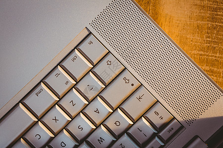 特写笔记本电脑的视图技术键盘木头桌子阴影灰色背景图片