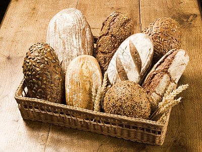 各种类型的面包褐色亚麻芝麻柳条商品种子食物桌子小麦向日葵图片