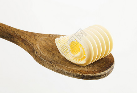 木勺上的黄油卷子食品卷曲食物传播用具厨房勺子烹饪奶制品图片