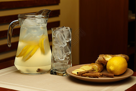 一杯含罐子和成分的甜柠檬水杯薄荷叶子饮料桌子草本植物水果饮食液体排毒食物图片