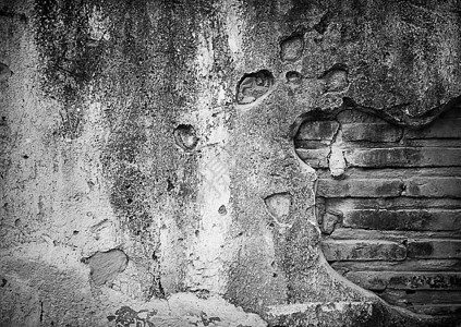 水泥墙壁灰色风化裂缝黑色石头白色古董材料图片